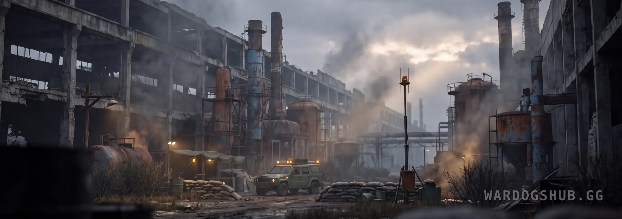 Un pequeño puesto rodeado de sacos terreros con un vehículo ligero aparcado y una antena, empequeñecido por las chimeneas y las naves destripadas de un complejo industrial abandonado al amanecer.
